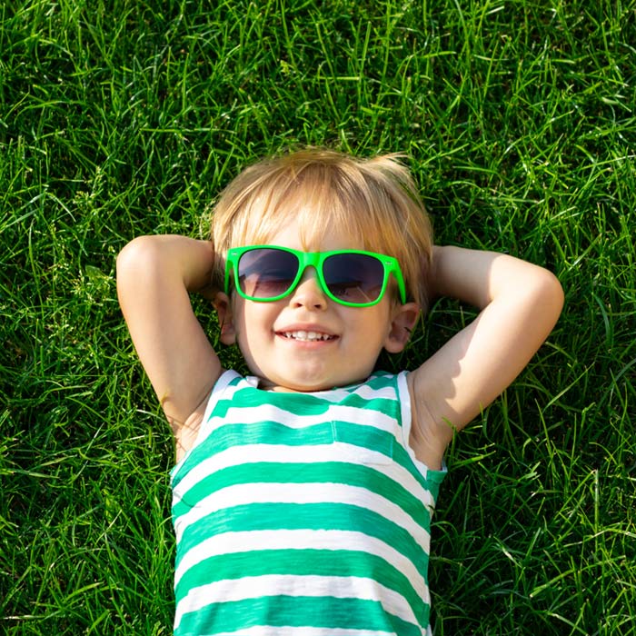 Young boy wearing green sunglasses
